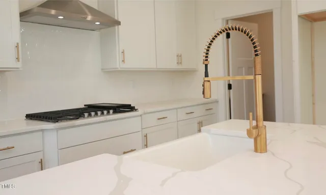 a kitchen with granite countertop cabinets and white appliances