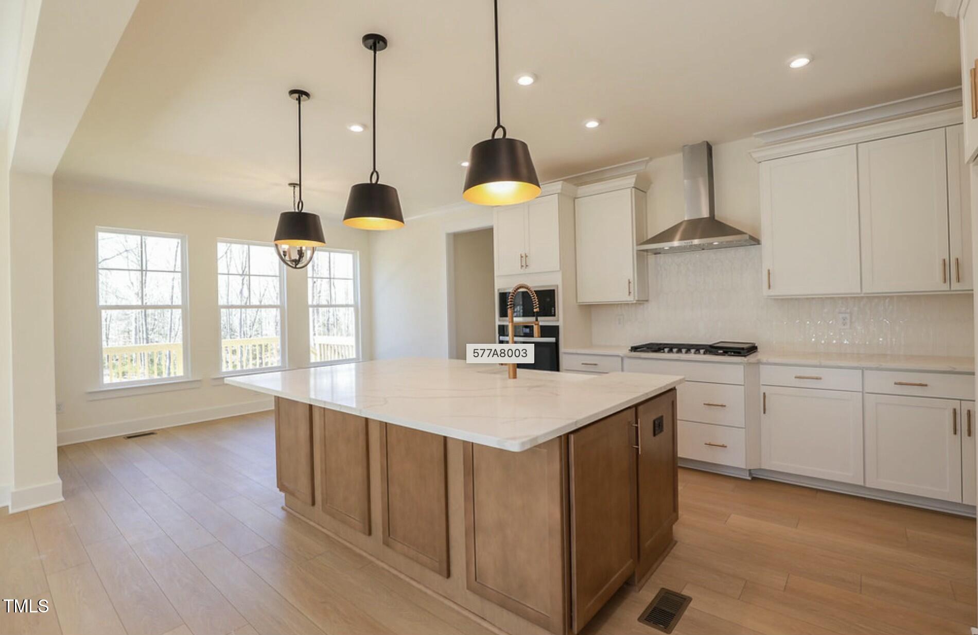 6 Tallulah Loop Cedar Grove, NC 27231 - Photo 10 of 17 a kitchen with counter top space sink stove and wooden floor