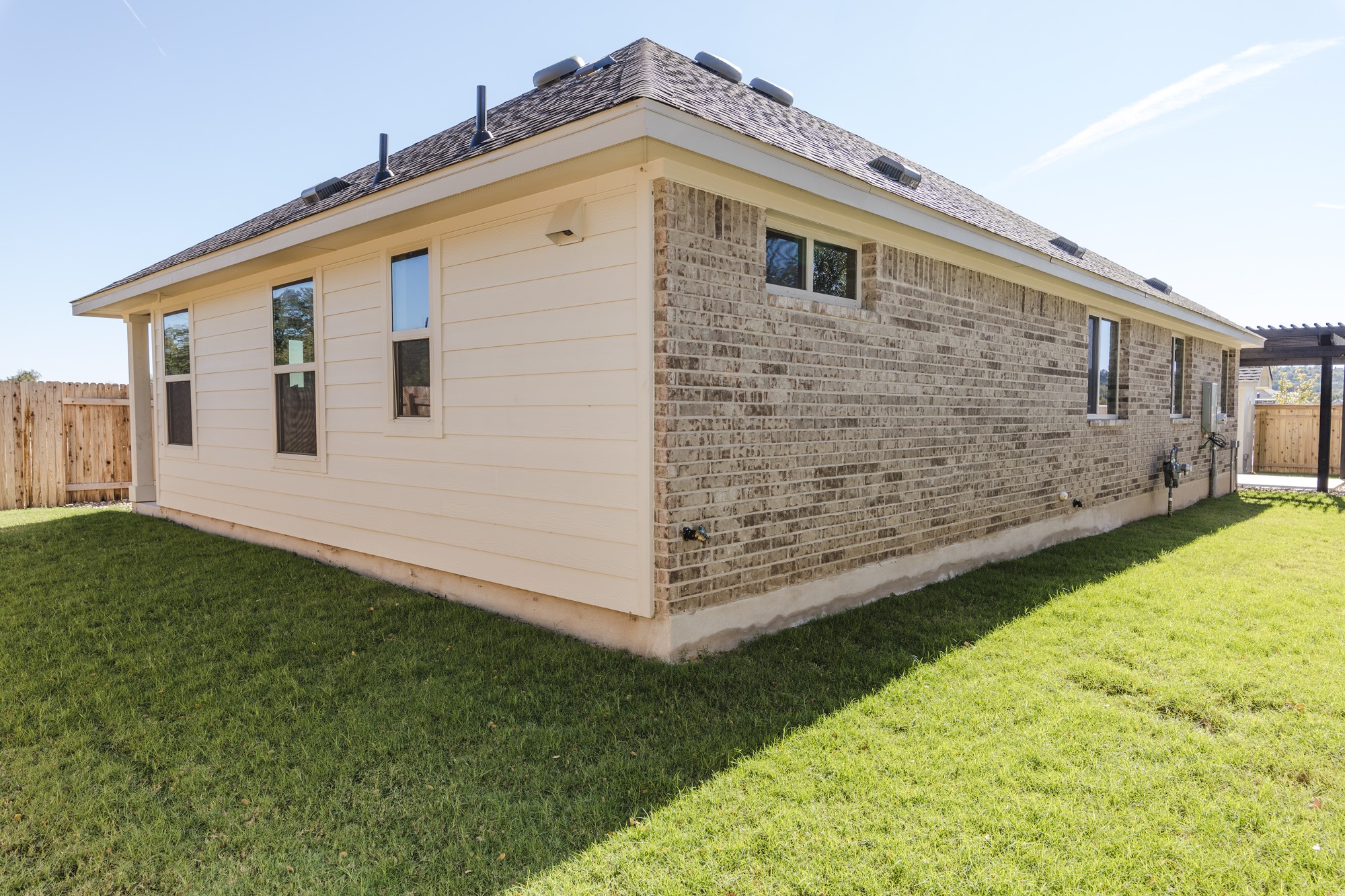2725 Hopi Path Leander, TX 78641 - Photo 7 of 30 A well-maintained lawn surrounds this charming home with brick and siding details.