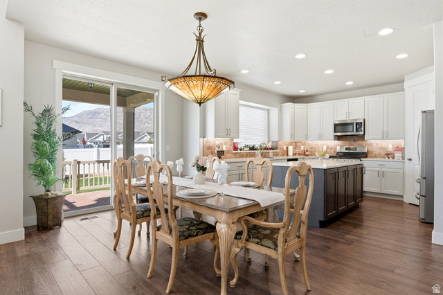 1434 West Stable Street Lindon, UT 84042 - Photo 12 of 76 Dining area with healthy amount of natural light, recessed lighting, dark wood finished floors, and a mountain view