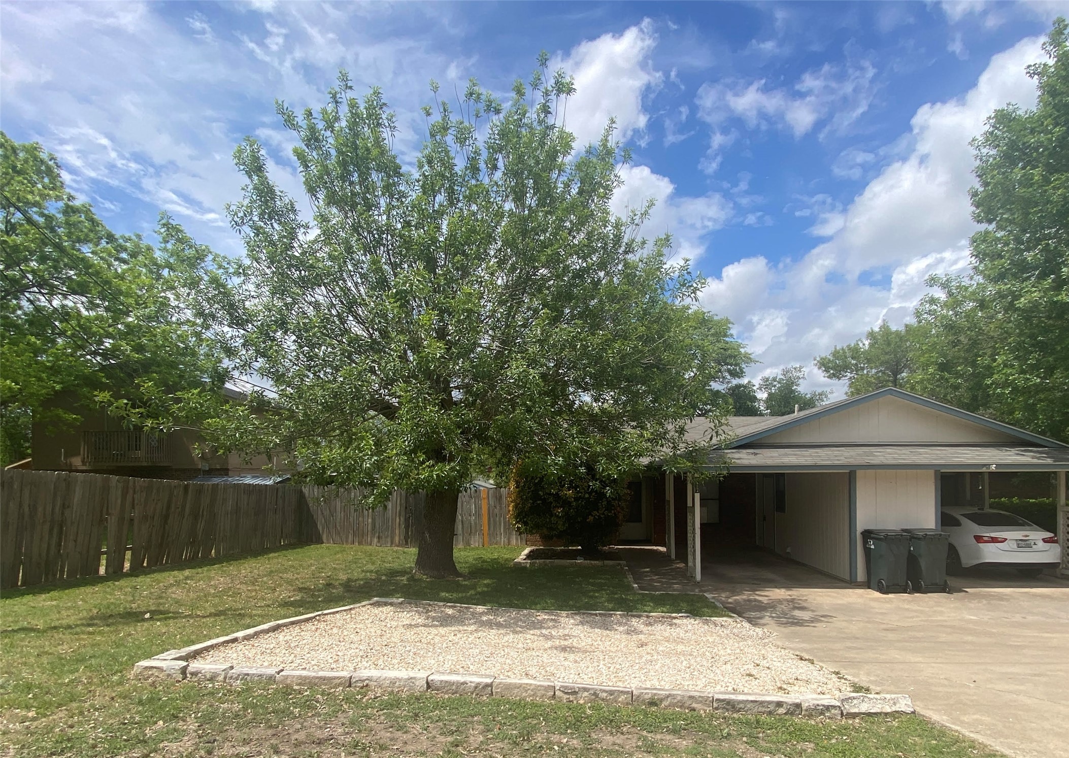 a backyard of a house with table and chairs