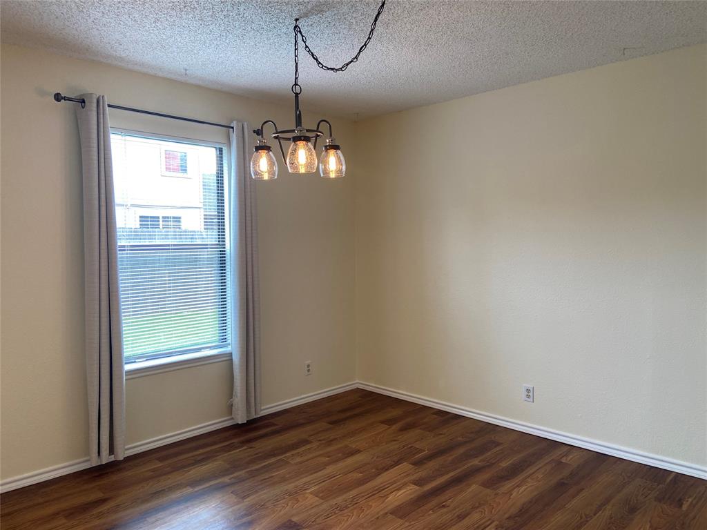 12800 Old San Antonio Road, Unit A Manchaca, TX 78652 - Photo 12 of 39 a view of an empty room with wooden floor and a window