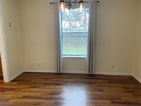 a view of wooden floor and windows in a room