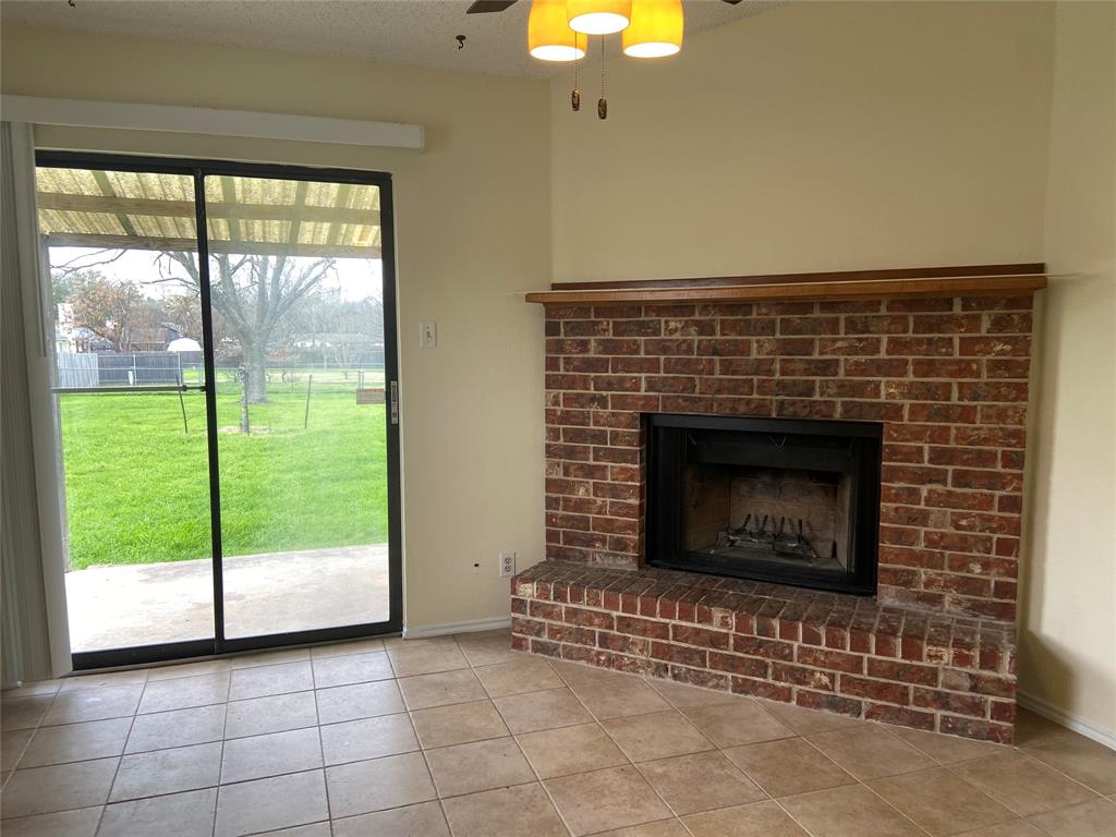 12800 Old San Antonio Road, Unit A Manchaca, TX 78652 - Photo 15 of 39 a living room with a fireplace and a large window