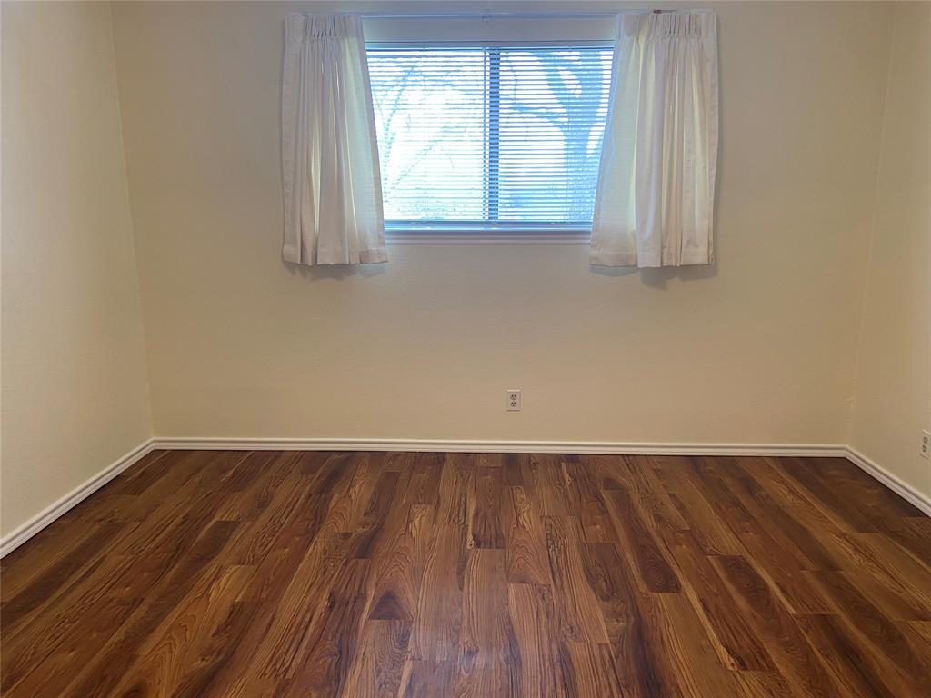 12800 Old San Antonio Road, Unit A Manchaca, TX 78652 - Photo 16 of 38 an empty room with wooden floor and windows