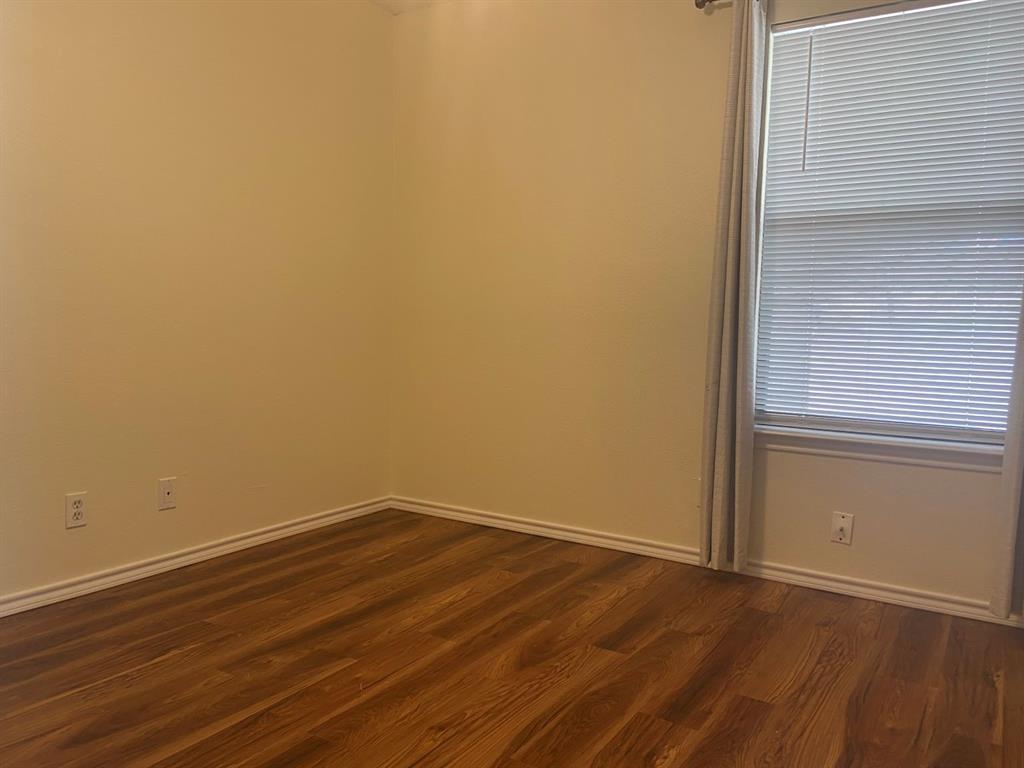 12800 Old San Antonio Road, Unit A Manchaca, TX 78652 - Photo 28 of 39 an empty room with wooden floor and windows