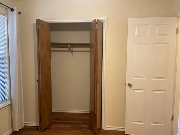 a view of walk in closet with empty room