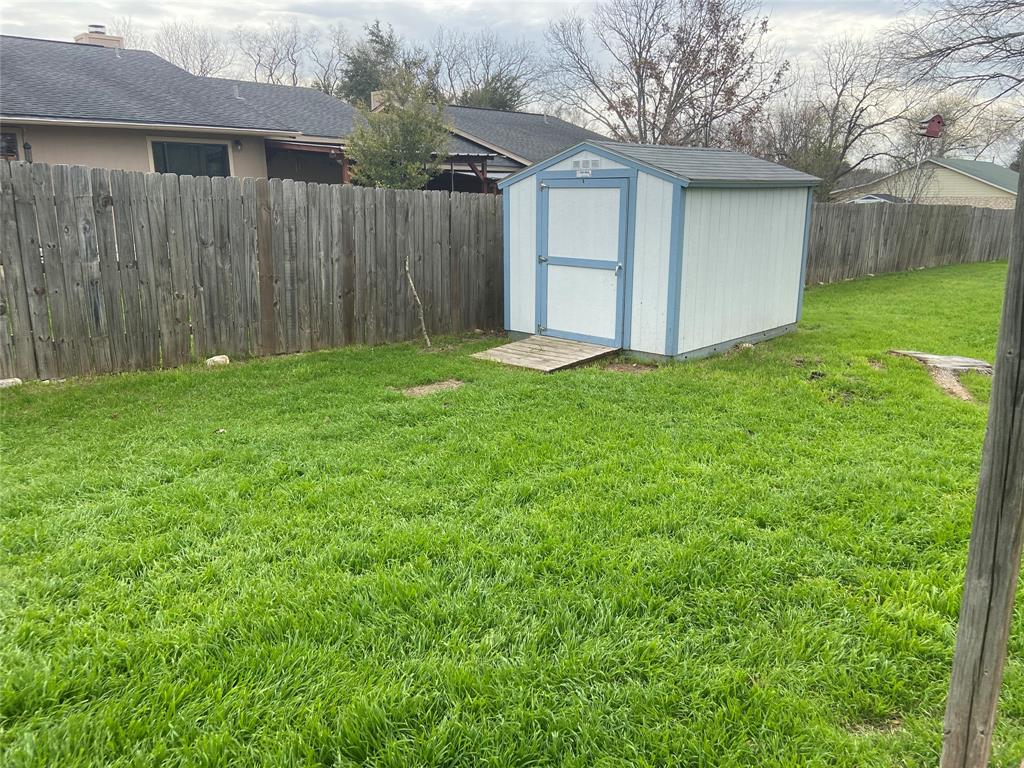 12800 Old San Antonio Road, Unit A Manchaca, TX 78652 - Photo 36 of 39 a view of a backyard with potted plants and wooden fence