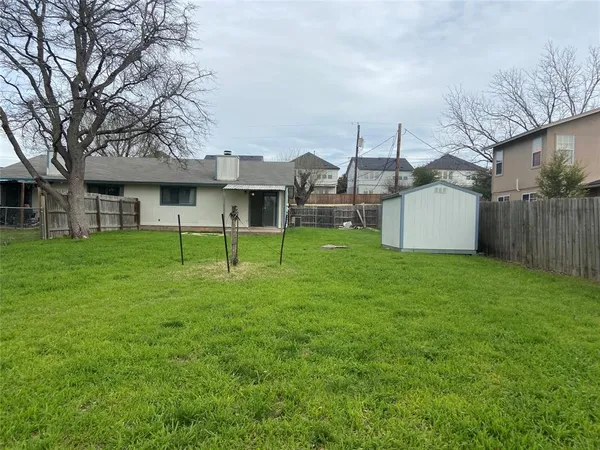 a view of a house with a yard and sitting area