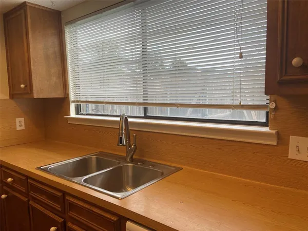 a view white kitchen island a sink a wooden floor and a window