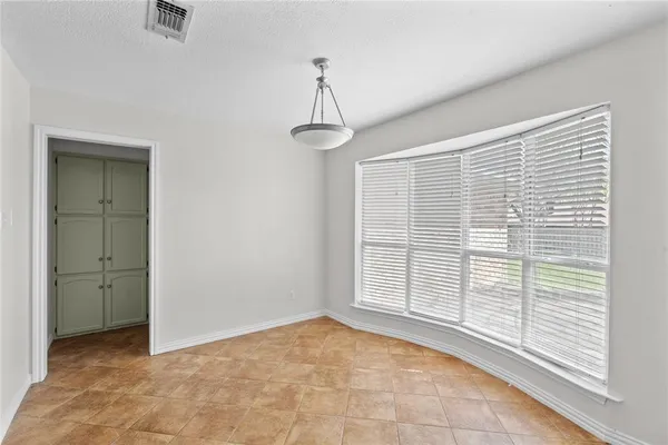 a view of small space with wooden floor and fan