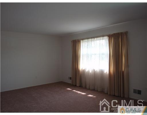 2 Valery Road, Unit 249 Old Bridge, NJ 07747 - Photo 5 of 7 an empty room with windows