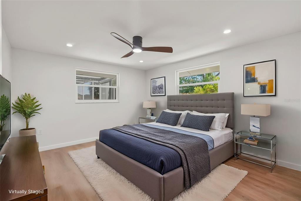 1330 Horizon Road Venice, FL 34293 - Photo 26 of 40 a bedroom with a large bed and a chandelier