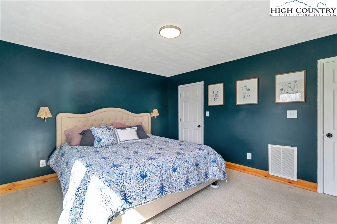 885 Alpine Drive Seven Devils, NC 28604 - Photo 20 of 50 a bedroom with a bed and painting on the wall