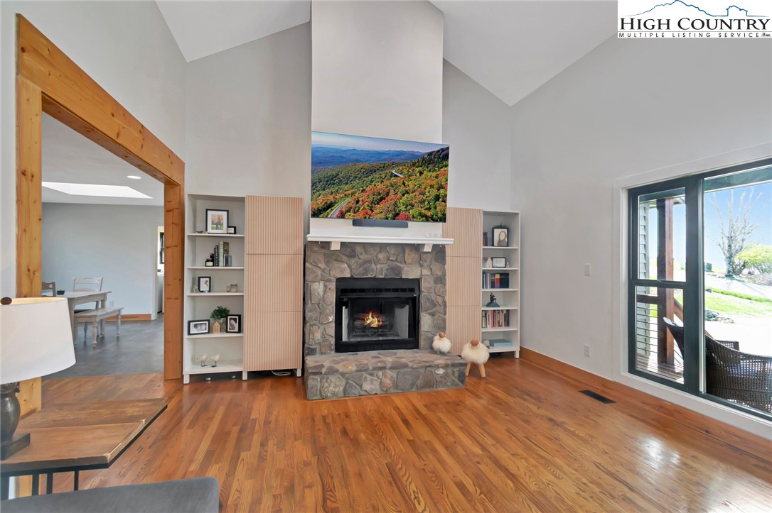 885 Alpine Drive Seven Devils, NC 28604 - Photo 6 of 50 a view of an empty room with fire place and wooden floor