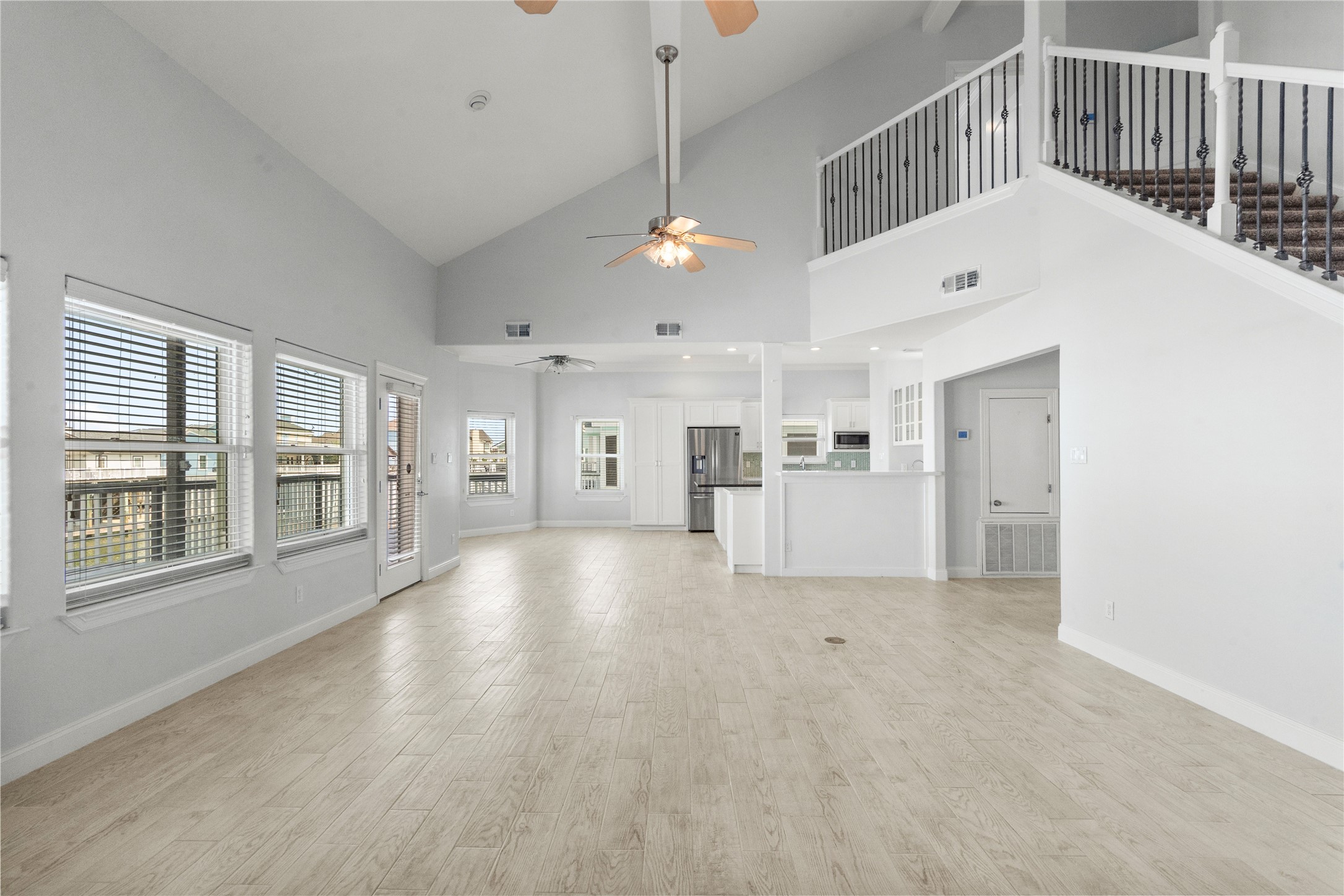 138 Isles End Road Galveston, TX 77554 - Photo 11 of 36 a view of empty room with wooden floor and windows