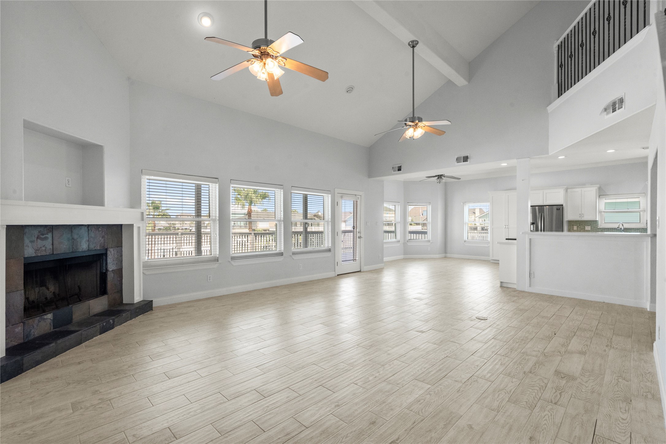 138 Isles End Road Galveston, TX 77554 - Photo 12 of 36 a view of an empty room with wooden floor and a fireplace