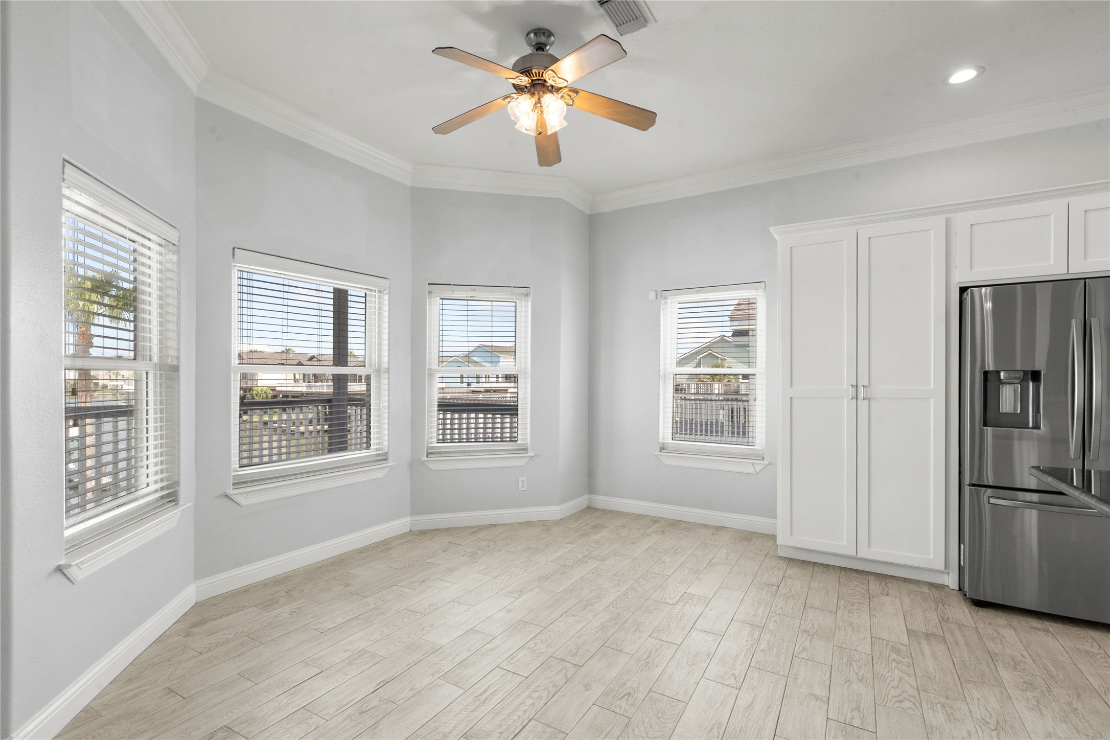138 Isles End Road Galveston, TX 77554 - Photo 13 of 36 a view of a kitchen with furniture ceiling fan and windows