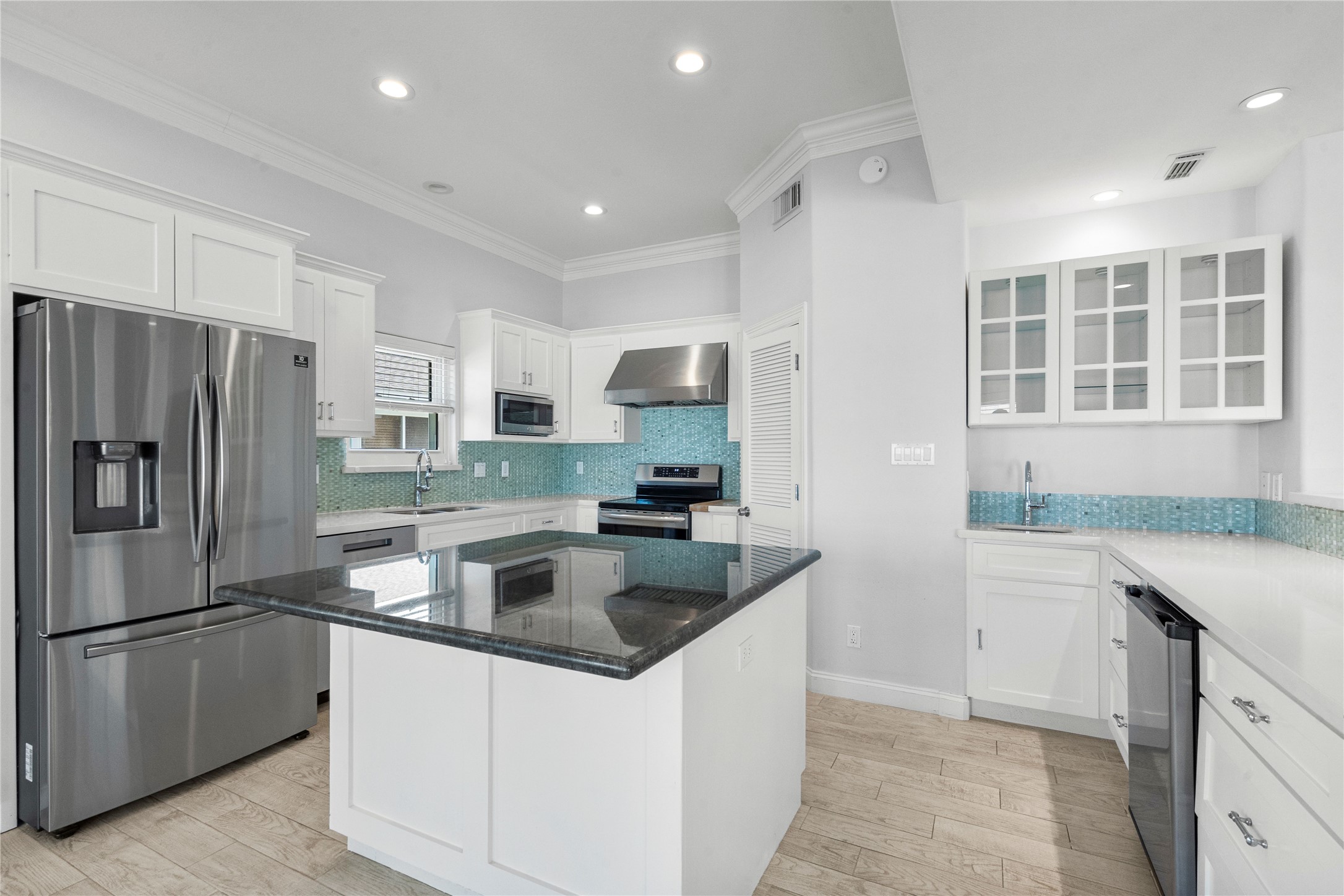 138 Isles End Road Galveston, TX 77554 - Photo 15 of 36 a kitchen with stainless steel appliances granite countertop a sink stove and refrigerator