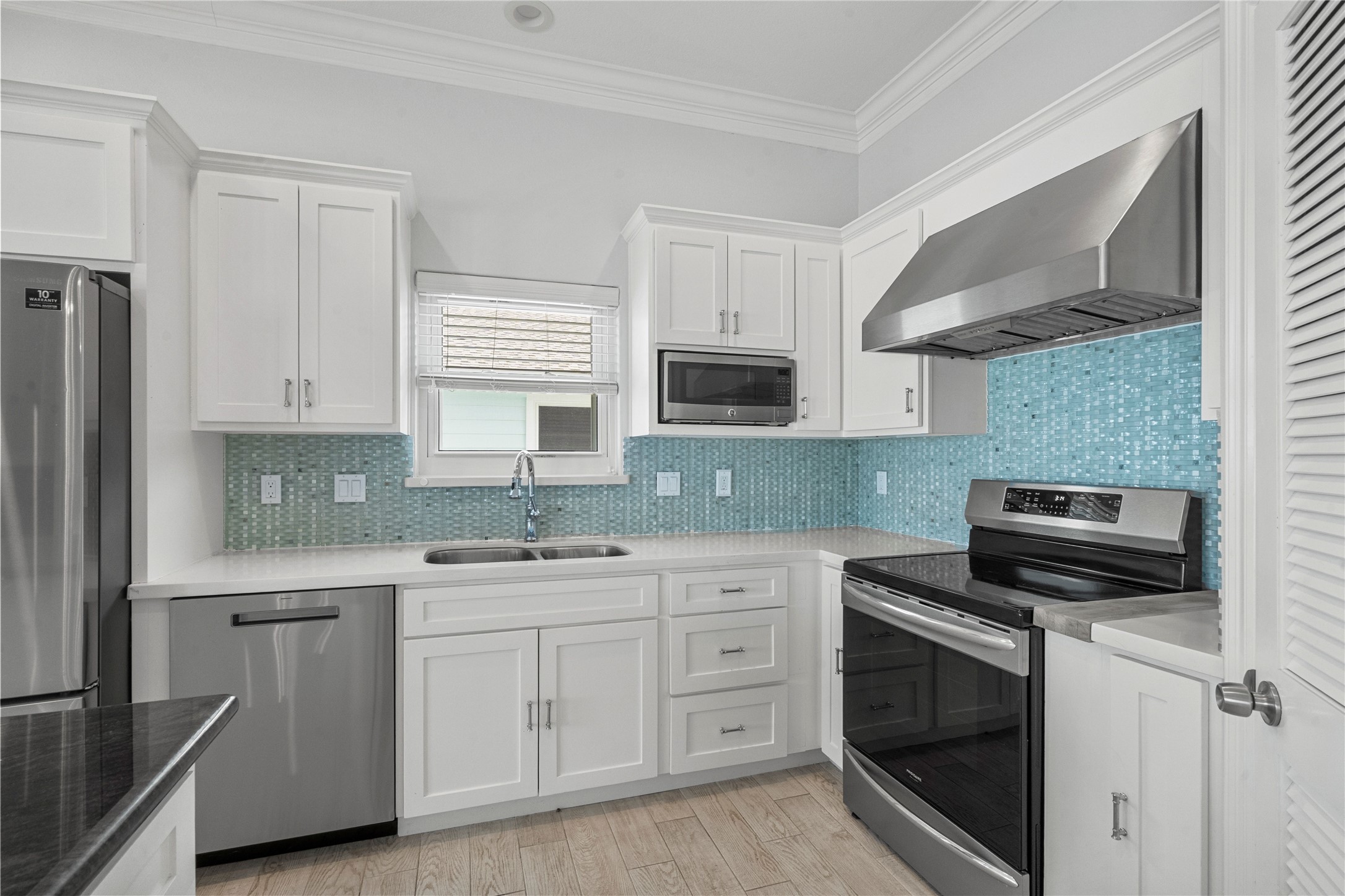 138 Isles End Road Galveston, TX 77554 - Photo 17 of 36 a kitchen with cabinets appliances a sink and a counter top space