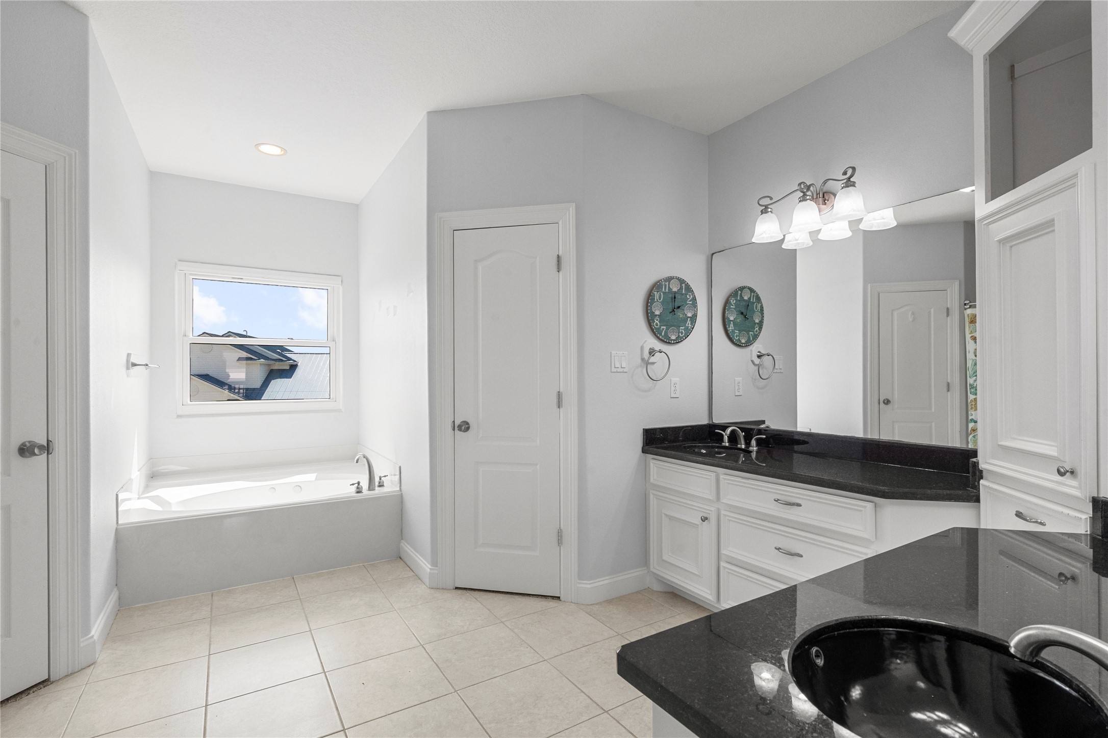 138 Isles End Road Galveston, TX 77554 - Photo 25 of 36 a bathroom with a sink a bathtub and a mirror