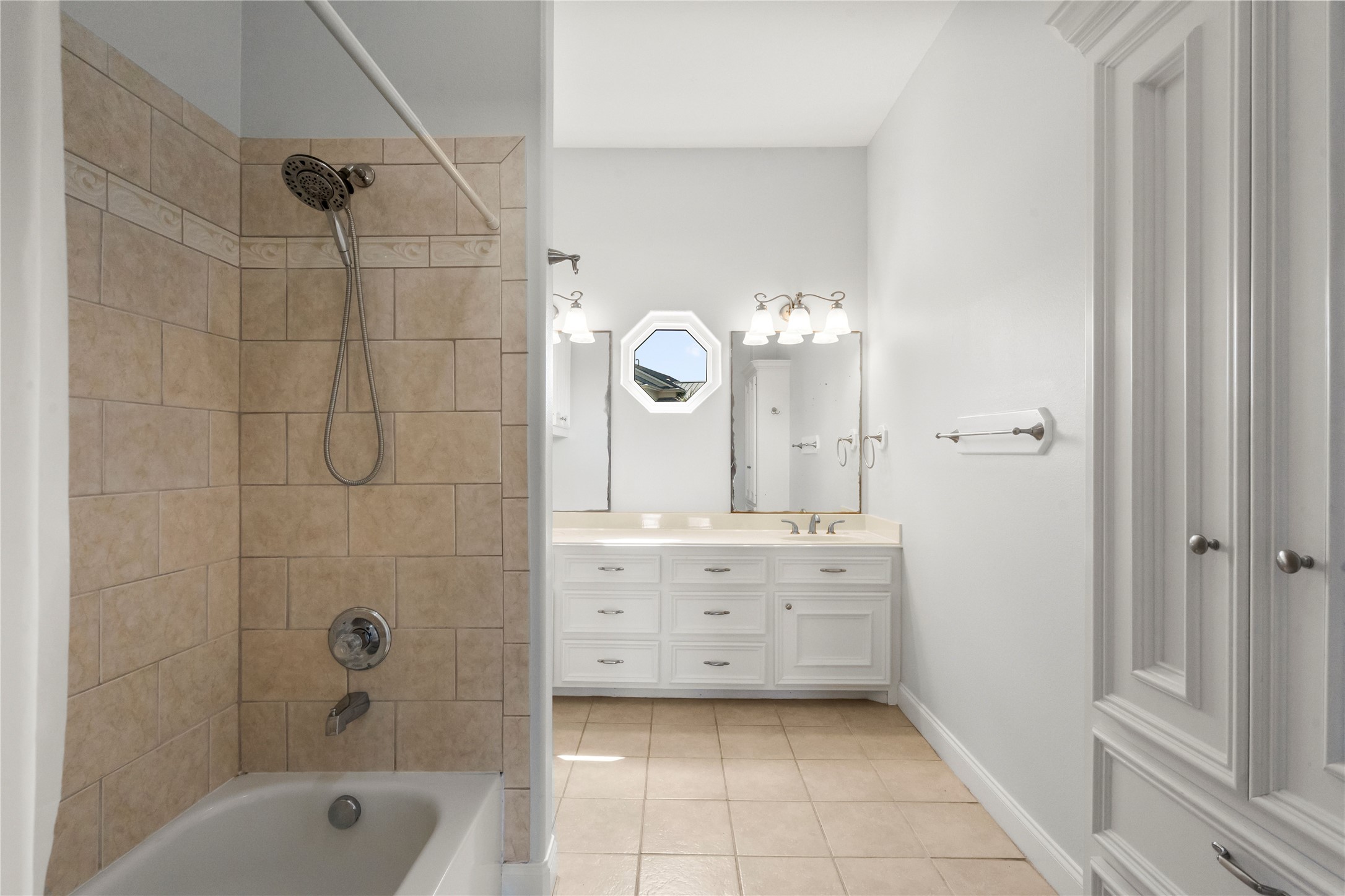 138 Isles End Road Galveston, TX 77554 - Photo 4 of 36 a bathroom with a double vanity sink mirror bathtub and shower
