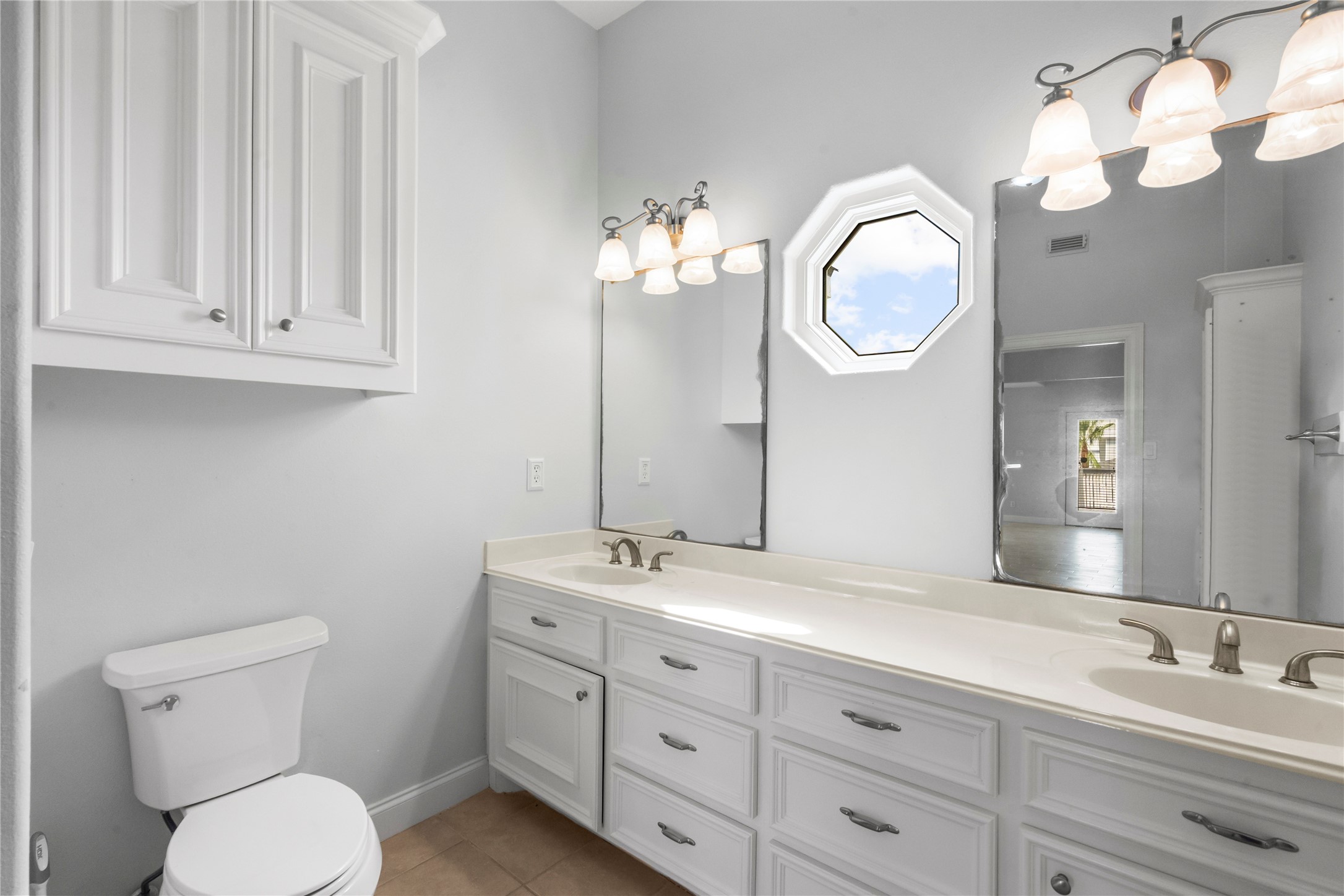 138 Isles End Road Galveston, TX 77554 - Photo 5 of 36 a bathroom with a toilet a sink and mirror