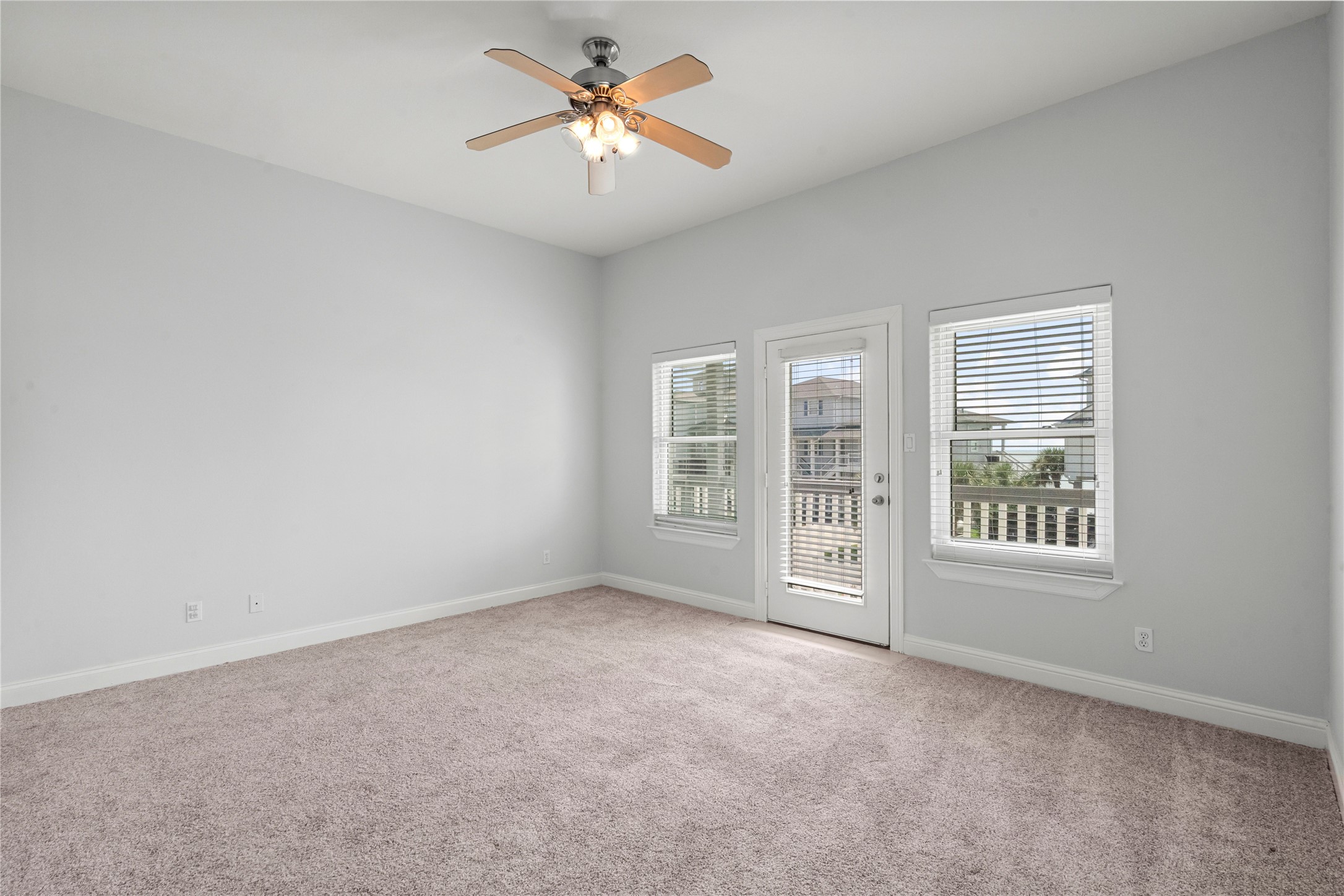 138 Isles End Road Galveston, TX 77554 - Photo 8 of 36 an empty room with windows and chandelier fan