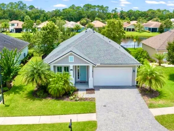 a house with green field in front of it