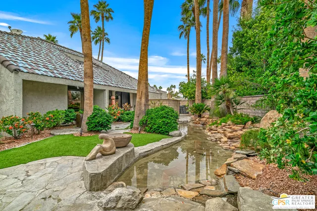 a view of a patio with couches and chairs with wooden floor
