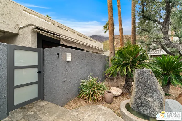 a living room with furniture a large window and a table