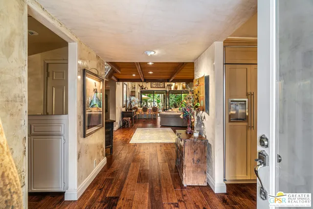 a view of a patio with table and chairs potted plants with wooden floor