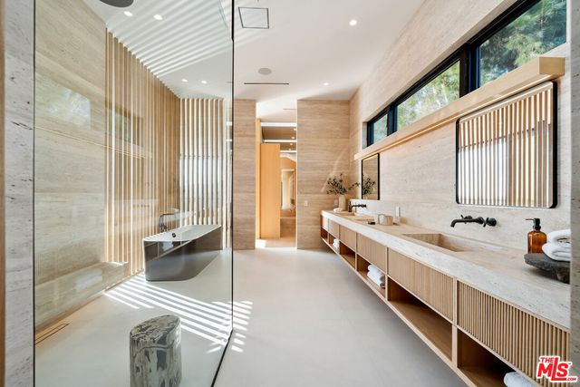 a large white room with a large window and chandelier