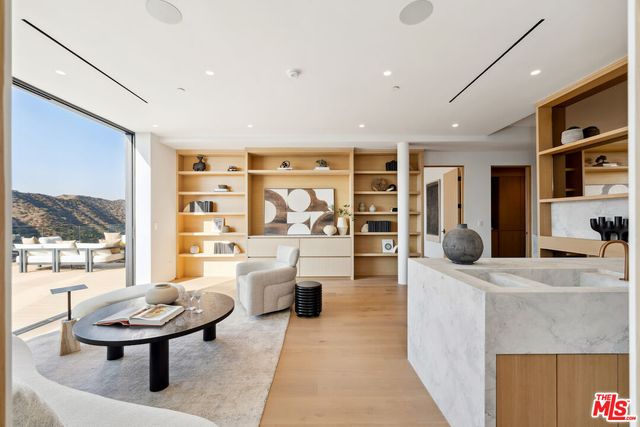 a living room with fireplace furniture and a large window