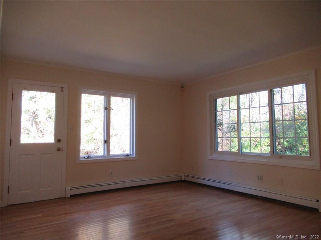11 Burnt Swamp Road Woodbridge, CT 06525 - Photo 14 of 29 a view of an empty room with wooden floor and a window