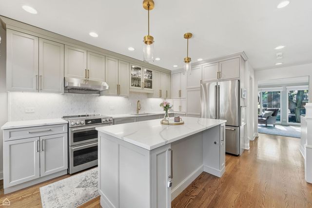 a kitchen with a sink stove and refrigerator