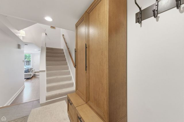 a view of a hallway with wooden floor and entryway