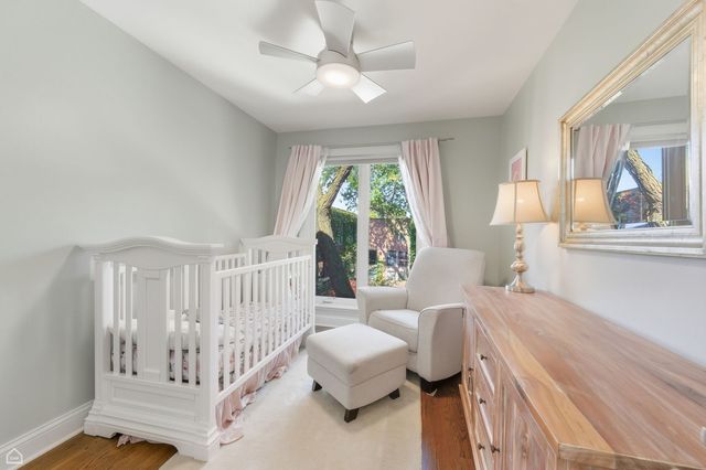 a bedroom with furniture and a large window