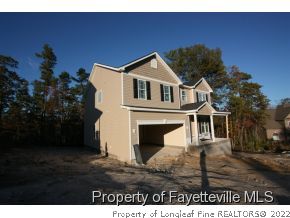 209 Culpepper Road Cameron, NC 28326 - Photo 2 of 17 a front view of a house with a garden