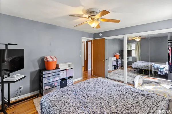a bedroom with furniture and a flat screen tv