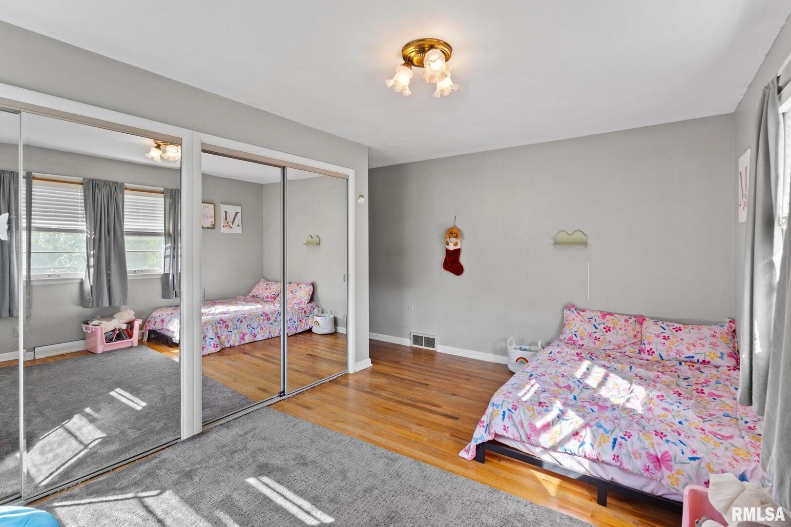 2552 37th Avenue Rock Island, IL 61201 - Photo 15 of 33 a bedroom with a bed and a chandelier