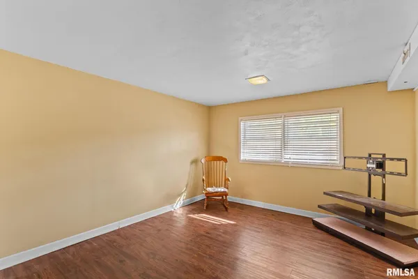 a room with gym equipment on wooden floor