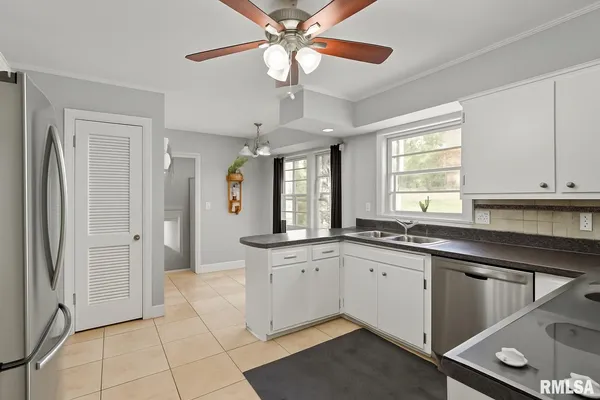 a large kitchen with a large window cabinets and stainless steel appliances