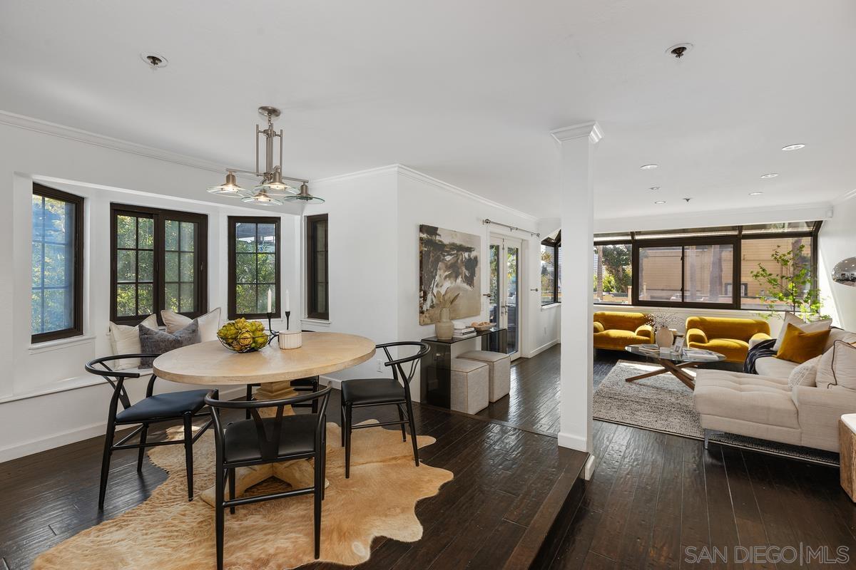 a view of a dining room with furniture window and wooden floor