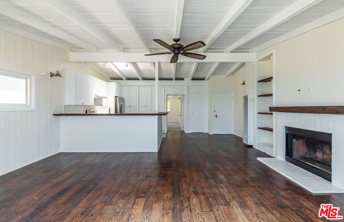 25408 Malibu Road, Unit 1/2 Malibu, CA 90265 - Photo 12 of 19 a view of a kitchen with wooden floor and a fireplace