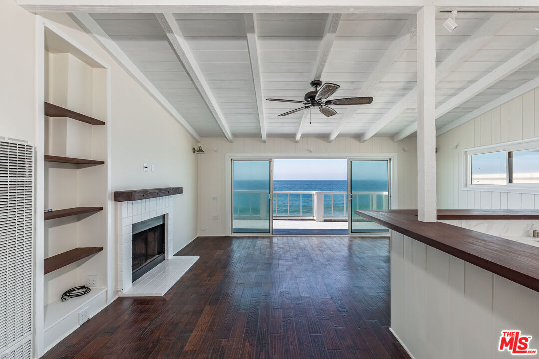 25408 Malibu Road, Unit 1/2 Malibu, CA 90265 - Photo 6 of 19 a view of an empty room with a window and wooden floor