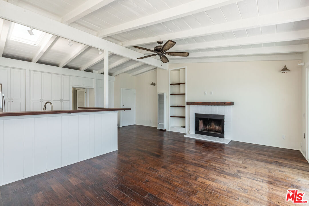 25408 Malibu Road, Unit 1/2 Malibu, CA 90265 - Photo 10 of 19 a view of empty room with wooden floor and a fireplace