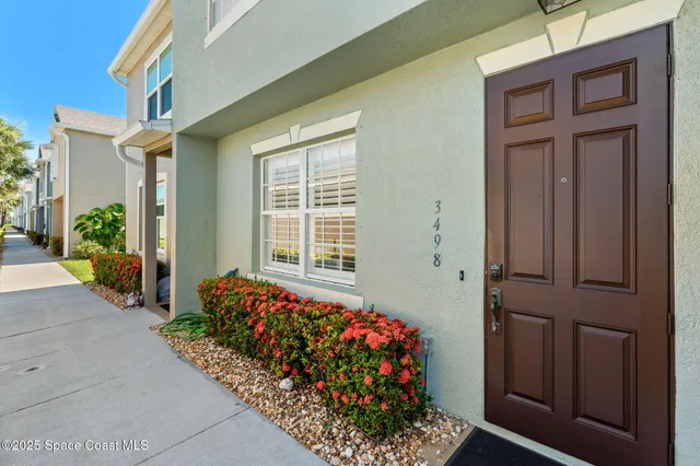 front of a house with a potted plant