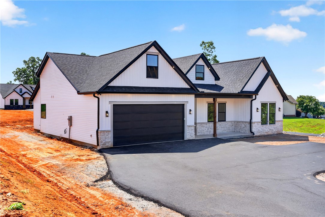416 Blume Road Anderson, SC 29625 - Photo 3 of 29 A newly constructed residence showcases a crisp white exterior, dark gabled rooflines, and a spacious attached garage.