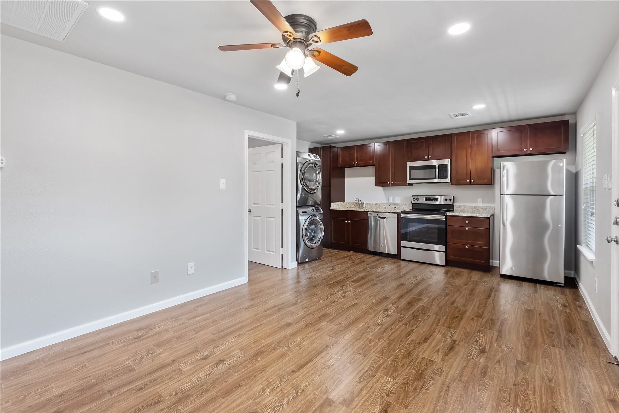 1110 West Patton Street, Unit 4 Houston, TX 77009 - Photo 5 of 8 a view of kitchen with refrigerator microwave and stove
